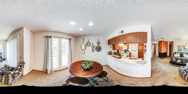 Dining area and kitchen in a multifamily apartment.