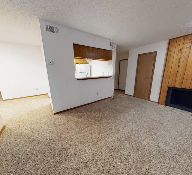 Living room with fireplace and pass-through to kitchen