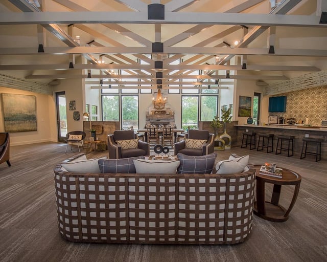 Spacious community lounge with contemporary seating, a fireplace, and a bar area.