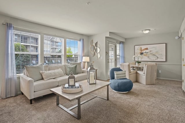 Living room and dining area with sofa, coffee table, and dining set.