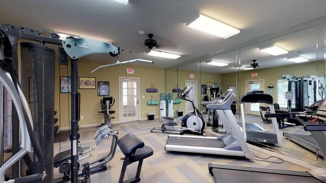 Fitness center with treadmills, elliptical, and weight machines.