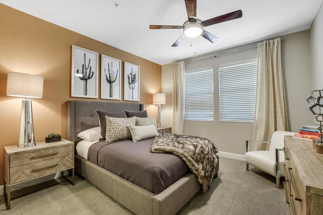 Stylish bedroom with a queen-size bed, modern nightstand, and wall art.