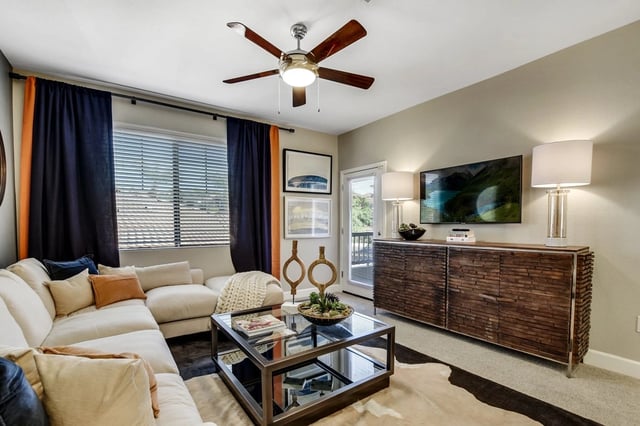 Living room with a sectional sofa, coffee table, and television.