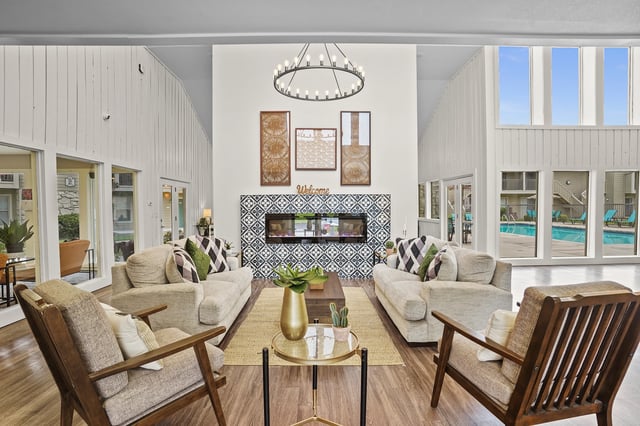 Exterior view of apartment buildings with a walkway and grass.