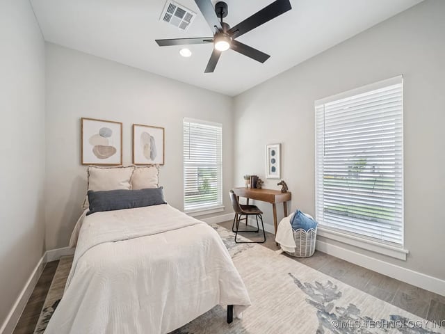 Cozy bedroom with a single bed, desk, and decor.