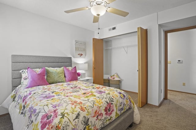 Living room and kitchen area of a modern apartment with a fireplace and dining table.