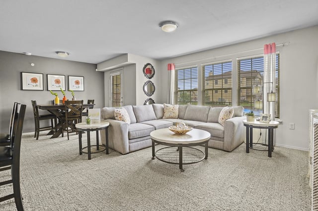 Living room with a sectional sofa, coffee table, and dining area.