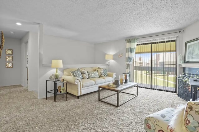 Cozy living room featuring a beige sofa and decorative table.