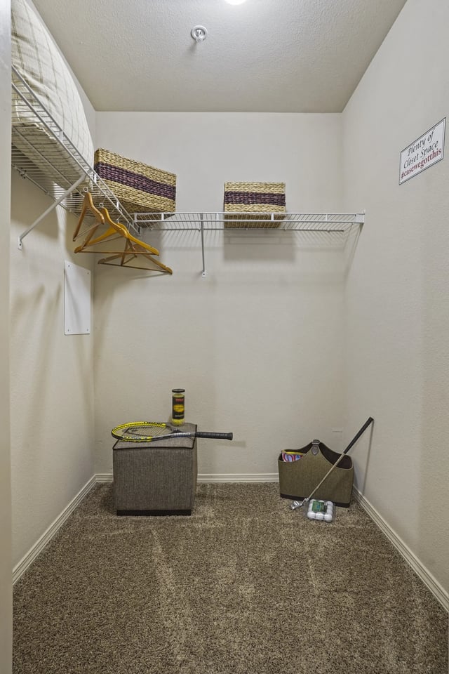 A room with a carpeted floor and a sign on the wall.