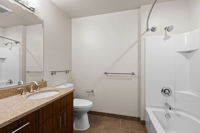 Bathroom with vanity, toilet, and bathtub with shower.