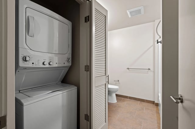 Stacked washer and dryer in a laundry closet.