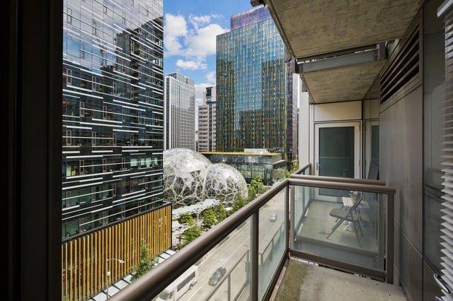 View from balcony overlooking city street, modern buildings, and the Amazon Spheres.