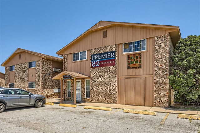Premier 82 Apartments building exterior with signage and entrance.