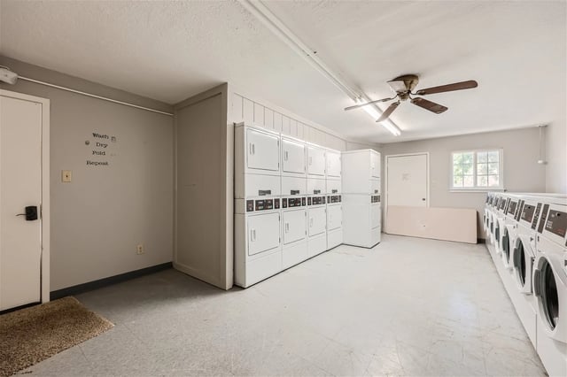 On-site laundry room with rows of washers and dryers.