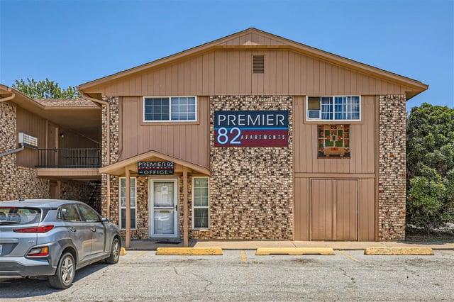 Premier 82 Apartments building exterior with signage.