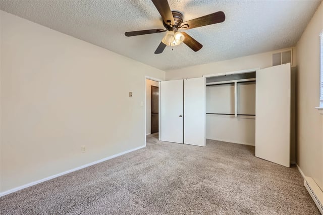 Bedroom with ceiling fan and open closet