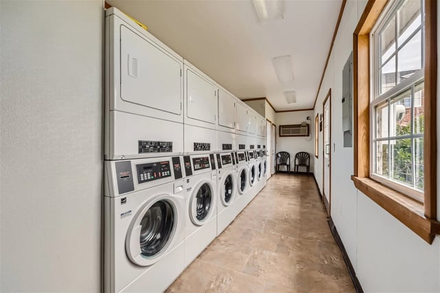 Laundry room with stacked washers and dryers