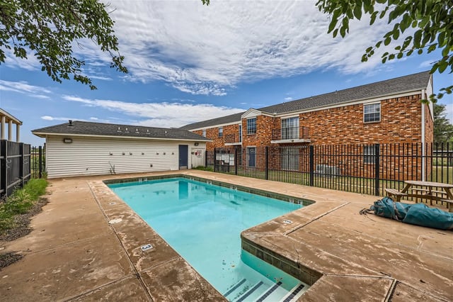 Swimming pool and apartment buildings on a cloudy day