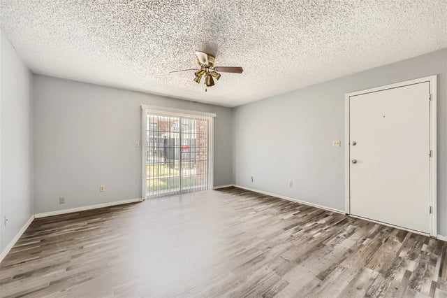 Living room with sliding glass doors and a ceiling fan.