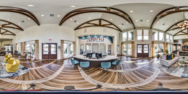 Welcome desk and lobby seating area of The Bend at New Road apartments.