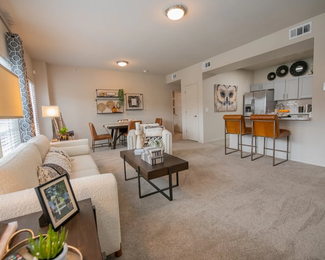 A living room with a white couch and a coffee table.