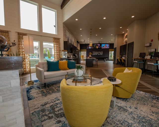 A living room with a yellow chair and a white couch.