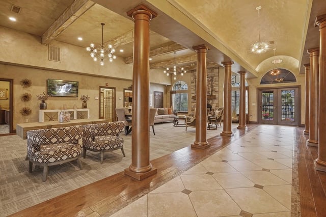 Elegant apartment community lounge area with seating and decor.