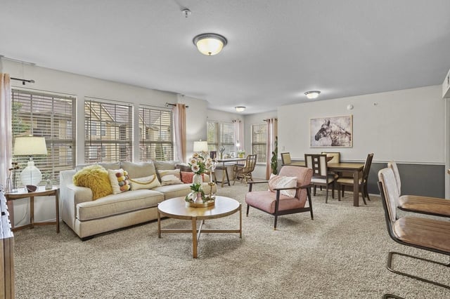 Living room and dining area with sofa, armchair, and dining table.
