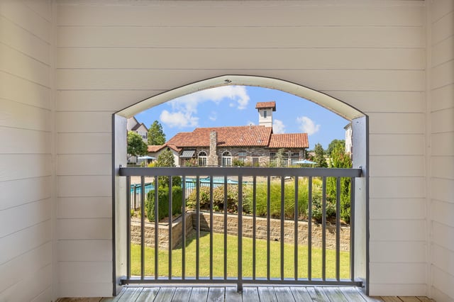 View of the community pool and clubhouse from a balcony.
