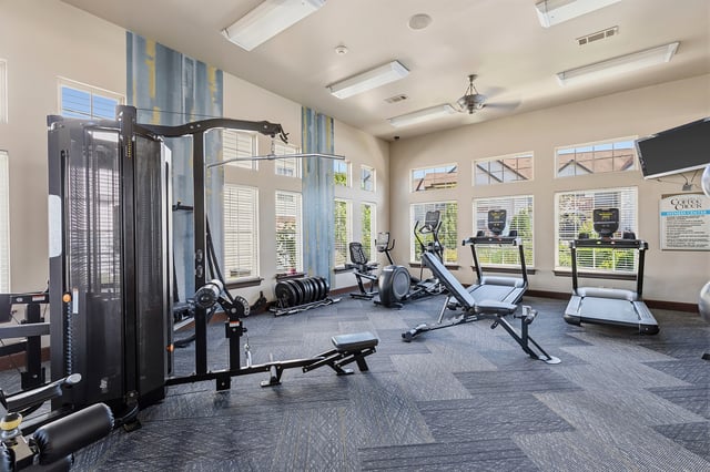 Fitness center with weight machines, treadmills, and elliptical.