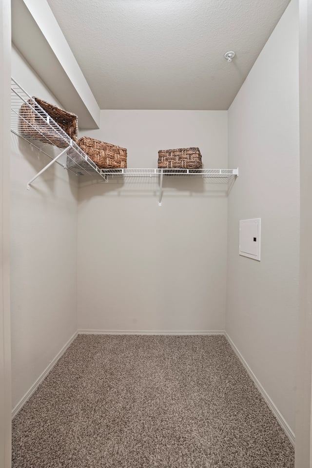 Empty closet with wire shelving and storage baskets