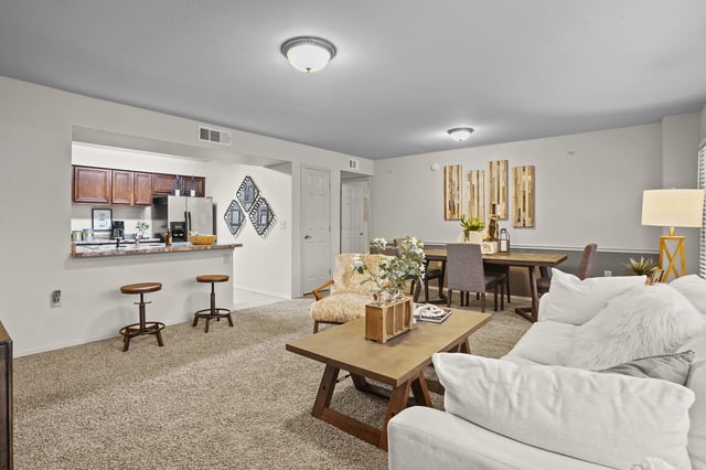 Cozy living and dining area with open kitchen and breakfast bar.