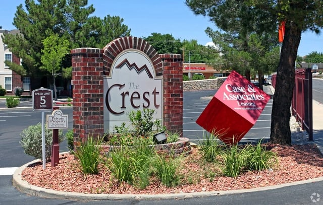 The Crest apartment complex monument sign with a speed limit and private property sign.