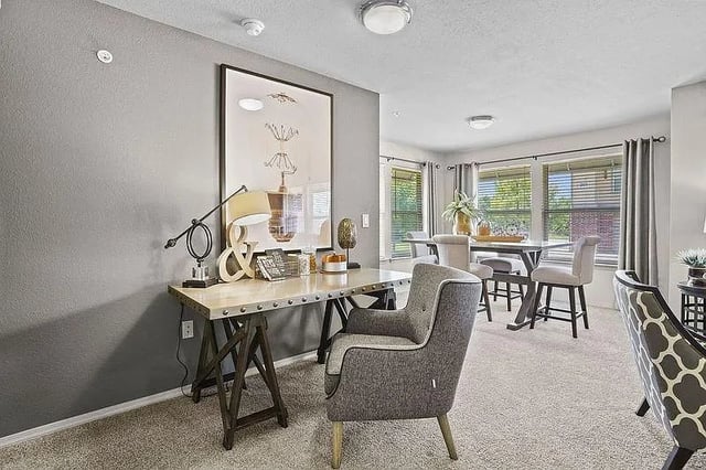 Home office desk with chair and dining area with table and chairs.