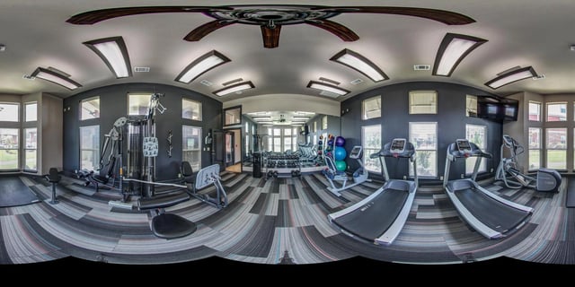 Fitness center with treadmills, elliptical, weight machines, and free weights.