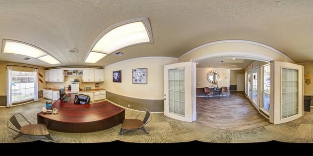 Reception desk and waiting area in a multifamily property's leasing office.