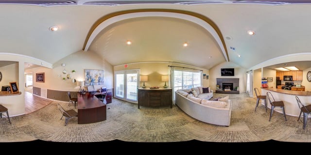 Leasing office and lounge area with seating, fireplace, and kitchenette.