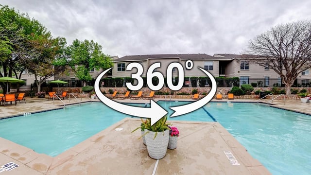 360 degree view of a swimming pool area with lounge chairs and apartment buildings in the background.