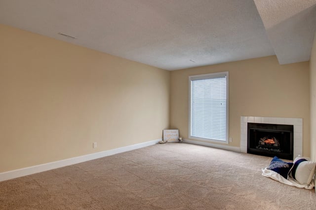 Living room with fireplace and large window