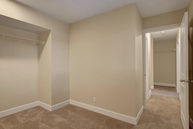 Empty bedroom with closet and hallway.