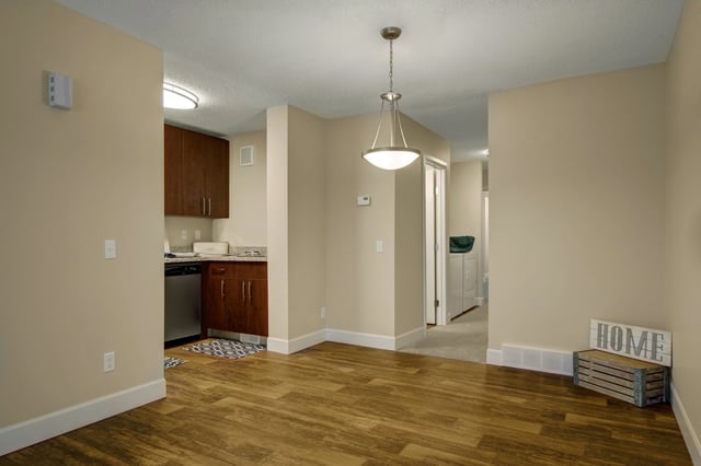 Living room with a view into the kitchen and laundry area.