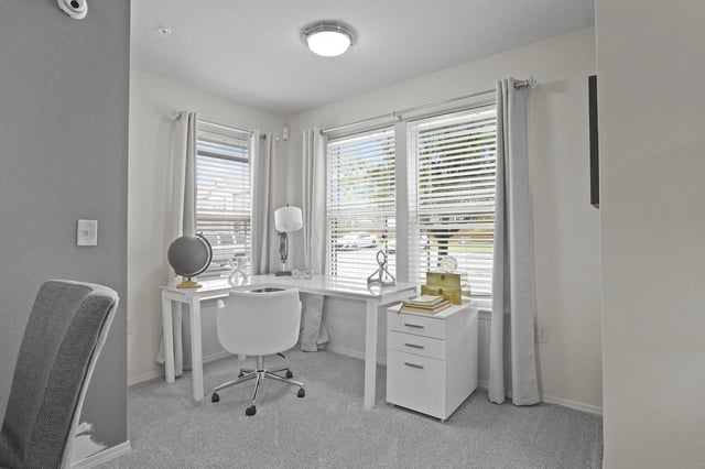 A white room with a desk and a chair.