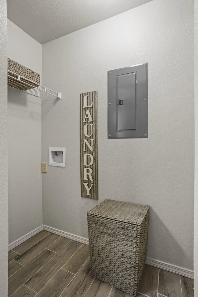 Laundry room with a basket and a sign.