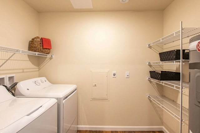 In-unit washer and dryer with shelving and a water heater.