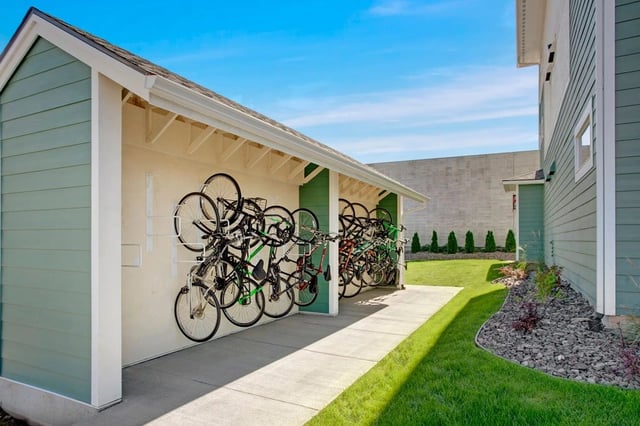 Outdoor bike rack with multiple bicycles stored vertically.