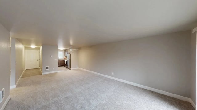 Spacious living room and kitchen area in an apartment.