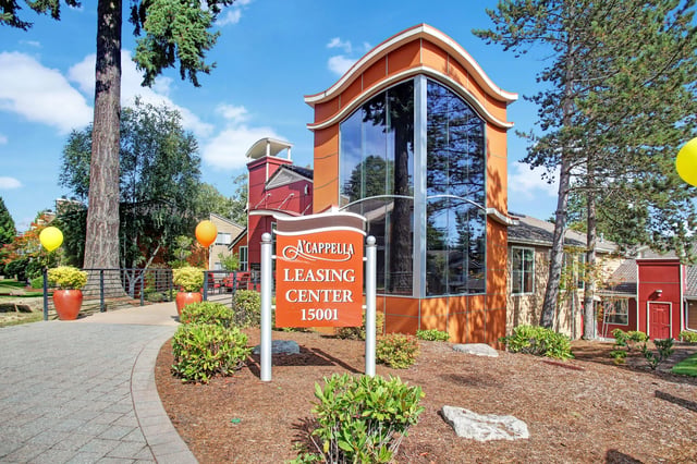 A'Cappella Leasing Center sign with balloons and modern building exterior.