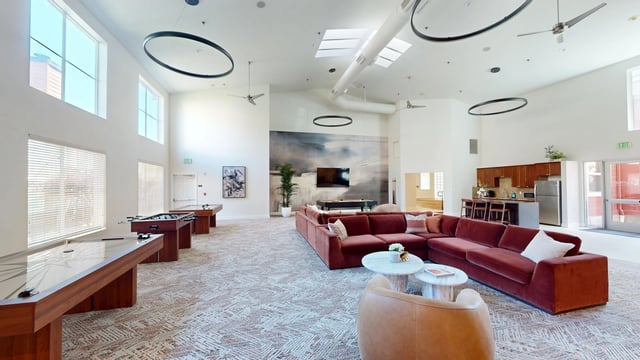Spacious community lounge with games and a kitchen area.