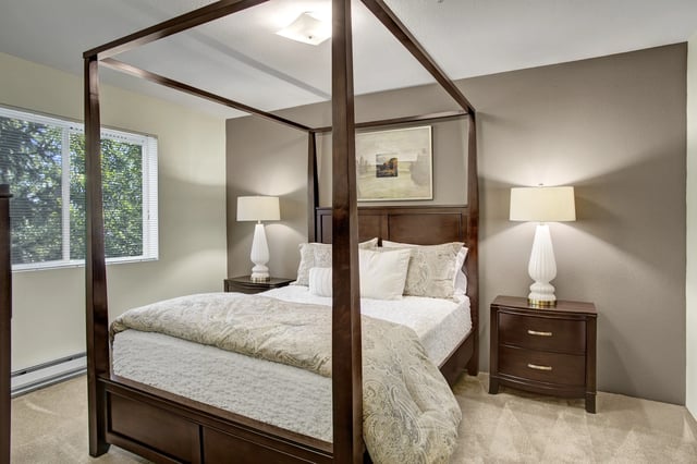 Bedroom with a four-poster bed, nightstands, and a window.