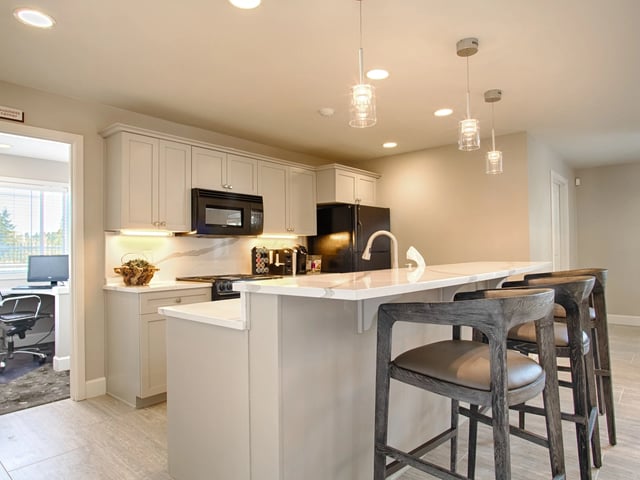 Modern kitchen with a breakfast bar and stools.